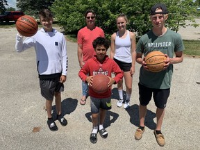 An outdoor basketball court will be built in the city’s downtown core and is expected to be ready by Aug. 1. Pictured back row from left: Bruce Whitaker and Jensen Pohl. Front row from left: Charlie Kuepfer, Quintin Whitaker and Nick McCabe. Cory Smith/The Beacon Herald