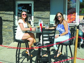 WELCOME SUMMER: Sam and Toni take to the patios for a change of scenery while enjoying a cool beverage at the Sportscentre Bar and Grill on Wellington Street West over the weekend. ALLANA PLAUNT/SAULT THIS WEEK
