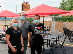 From left, John's Restaurant staff member Jess Edwards, owner Leo Stathakis and staffer Jonathan Ledarda stand in the restaurant's new patio on Monday, June 22.
(TERRY BRIDGE/The Observer)