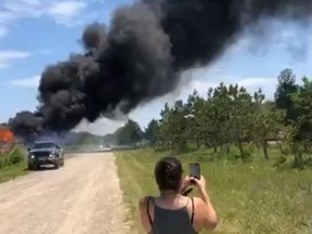 Smoke rises from the remains of a shop on Kettle and Stony Point First Nation Friday, in this screenshot from a video posted to Facebook by a member of the First Nation. Tensions flared as members of the First Nation moved to evict operators Friday at smoke and cannabis shops on former Camp Ipperwash land.