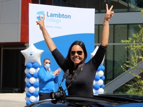Diane Queiroz takes part in a graduate celebration parade hosted Wednesday at Lambton College. About 500 recent graduates and their families drove through the college campus and received a gift to mark their success. The college's traditional convocation was cancelled due to COVID-19. PAUL MORDEN / THE OBSERVER