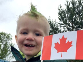 Rhyder Grenier waves the flag during Canada Day celebrations in Spruce Grove in 2019. The City cancelled the event for this year because of the COVID-19 pandemic. File photo