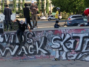 A Spruce Grove skate park user tests out some of the newest grafitti art painted on one of the ramps. The mural reads 'Covid Sucks Skate Hard" Photo by Josh Thomas.