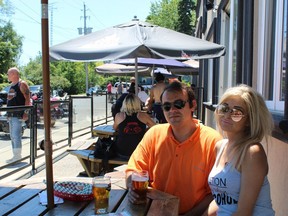 Anna Niedvala of Mississauga and Chris Siannis of Markham enjoy a beer on Saturday on the patio at Southside Louie's in Port Dover. MICHELLE RUBY PHOTO