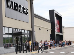 Shoppers line up as they wait their turn to enter Winners and HomeSense on Marcus Drive last Thursday as stores began to reopen in Sudbury.