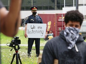 Greater Sudbury Police Chief Paul Pedersen looks on as hundreds of people participate in a protest against racism and police brutality in Sudbury, Ont. on Wednesday June 3, 2020.