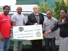 Nigerian Community Greater Sudbury representatives Olaniyi Alo, left, area director, Adetunji Akintonde, secretary, Adejare Muniru Oduwole, president, and Bukola Opara, welfare officer, present a $2,500 cheque to Geoffrey Lougheed, past chair of the Sudbury Food Bank, at a presentation in Sudbury, Ont. on Friday June 5, 2020. The donation will provide food for individuals and families needing food assistance in Greater Sudbury.