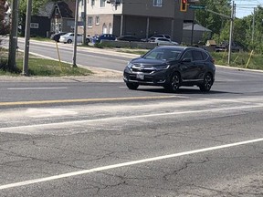 A turn lane at the intersection of Falconbridge Road/Church Street/Garson-Coniston Road in Garson Monday morning shows residue from soda ash used to treat a sulphuric acid leak Friday.