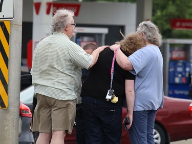 A woman speaks to a police officer while being comforted at the scene of a multi-vehicle collision at the intersection of Lasalle Boulevard and Notre Dame Avenue in Sudbury, Ont. on Wednesday June 10, 2020. Greater Sudbury Police, the fire department and EMS workers attended the scene. John Lappa/Sudbury Star/Postmedia Network