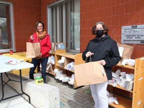 Tammy Deamicis, left, and Colette Paquette, of the Greater Sudbury Public Library in New Sudbury, display reserved items on Thursday June 11, 2020. Greater Sudbury Public Library locations in Greater Sudbury are now offering curbside pickup of previously reserved items that include books, magazines, DVDs and other library materials that were reserved prior to March 16, 2020. Scheduled pickups are being offered at the following locations; Chelmsford, Lively, Mackenzie Street location, New Sudbury, south end and Valley East. Items placed on hold from additional branches in the community will be available for pickup at these locations. Drop boxes for returns are located at the six branches. Late fees remain waived until further notice.