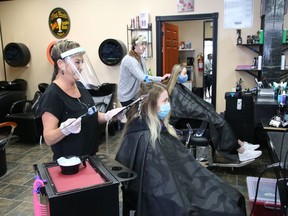 Lisa Comisso, left, adds highlights to Melissa Belanger's hair, while Danielle Cote styles Abby Redmond's hair at Hair Central Sudbury on Durham Street in Sudbury, Ont. on Friday June 12, 2020. Local barber shops, hair salons and hairdressers/stylists were allowed to open as part of the Ontario government's Stage 2 reopening plan.