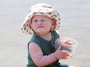 Gemma Vonmuhlenen, 1, cools off while playing at the main beach at Bell Park in Sudbury, Ont. on Monday June 15, 2020. Environment Canada said Greater Sudbury can expect mainly sunny skies with a high of 25 C on Tuesday.