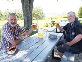 Rodney Guy, left, and John Martin have a drink on the patio at Branch 76 of the Royal Canadian Legion in Sudbury on Tuesday. The legion just reopened the patio that overlooks Ramsey Lake. The patio is open this week, Tuesday to Thursday from 2 p.m. to 6 p.m., and Friday and Saturday from 2 p.m. to 8 p.m. Next week the patio should be open on Monday as well.