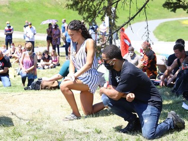 TiCarra Paquet and Liam Cousineau take a knee during a moment of silence at the Black Lives Matter: Juneteenth Racial Injustice Rally at Bell Park in Sudbury, Ont. on Friday June 19, 2020. John Lappa/Sudbury Star/Postmedia Network