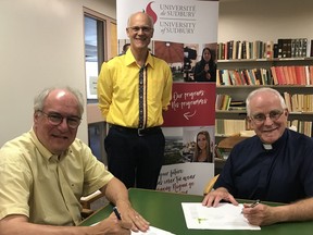 Pierre Riopel (left), chair of the University of Sudbury board of regents, Father John Meehan, sj, University of Sudbury president and vice-chancellor, and Father Erik Oland, sj, Provincial Superior of the Jesuits of Canada, sign an endorsement agreement with the Jesuits of Canada. Supplied photo