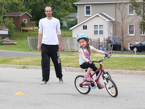 Mya Lawson, 5, follows an obstacle course set up by her dad, Scott, in the parking lot at the Delki Dozzi Sports Complex in Gatchell on Tuesday. Her dad prepared the course to teach his daughter to have control and confidence while riding her bicycle.
