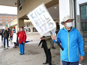Pat Byrne, right, takes part in a protest organized by the Sudbury chapter of the Ontario Health Coalition on Wednesday.