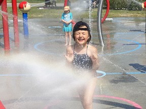 Elliot Venedam, 7, foreground, and her sister Reese, 6, celebrate the last day of school by cooling off at the DJ Hancock Memorial splash pad on Walford Road. All 14 of Sudbury's splash pads are now open for the summer. The city reminds residents to follow public health guidelines while enjoying the splash parks, including distancing by two metres. Mary Katherine Keown/Sudbury Star