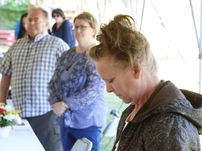 In this file photo, a moment of silence is held at the Workers' Memorial Day service at the Mine Mill Local 598/Unifor camp grounds in Sudbury. The event is held each year to remember the incident that occurred on June 20, 1984, when a seismic event measuring 3.5 on the Richter scale struck Falconbridge Mine around 10:12 a.m. The rockburst buried Wayne St. Michel, Sulo Korpela, Richard Chenier and Daniel Lavallee. The rockburst ultimately claimed their lives. This year, the event will be held virtually.