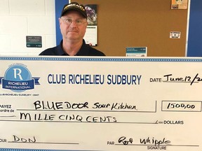Bill Hickey, manager of Blue Door Soup Kitchen, receives a $1,500 cheque from Club Richelieu Sudbury to help supply breakfasts and dinners to the homeless. Supplied photo