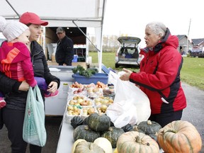 In this Daily Press file photo, Graham Acres owner Nicole Graham, right, chats with Caroline Filion with her daughter Rosalie Filion, 2, at the Mountjoy Farmers' Market in October 2019. The farmers' market returns for another season next month, but will operate at a smaller size.

RICHA BHOSALE/The Daily Press