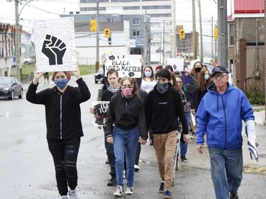 Demonstrators are seen marching along Algonquin Boulevard for an anti-racism held in front of Timmins city hall Wednesday.

RICHA BHOSALE/The Daily Press