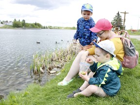 Polly Walsh with her sons, Hunter, 4, on her right and Deacon, 3, are seen feeding the ducks at Gillies Lake. Just like those ducks in the pond, Timmins residents can expect their surroundings to be wet as Environment Canada's forecast calls for rain for the rest of the week up to and including Friday.

RICHA BHOSALE/The Daily Press