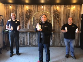 From left, Val Venneri, president of the Timmins Chamber, David Yaschyshyn, manager of environment and community for Glencore Kidd Operations, and Kevin Patriquin, a co-owner of Compass Brewing, are seen here holding some of the locally produced hand sanitizer that has been developed through the Chamber's Small Business PPE Support Grant program.

Supplied