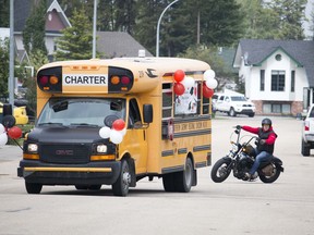 A chartered school bus carrying Hilltop High School teachers was followed by several vehicles - including Derek Schlosser on his motorcycle - around the hilltop area Thursday morning. Another bus with a second set of teachers toured the downtown area, suprising graduates with a celebratory visit.
Brigette Moore