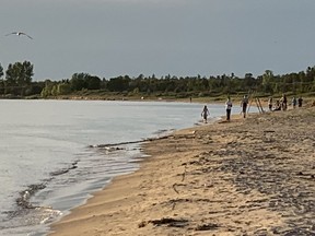 People walked along Sauble Beach the evening of June 9, the first day that the beach and other parks in South Bruce Peninsula were open for restricted use.