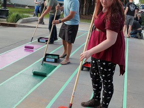 Wetaskiwin's Pride 
(front to back) Alexis Forth, Wetaskiwin Mayor Tyler Gandam and Krisen Schoendorfer took the first turn in repainting the rainbow colours on the crosswalks by Diamond Jubilee Park June 10 to celebrate Pride in Wetaskiwin for the second year.