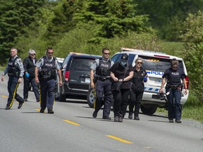 RCMP officers and staff from the medical examiner’s office attend the scene of a fatal dog attack in the rural community of Chaswood near Middle Musquodoboit, N.S. on Tuesday, June 9, 2020. A woman was killed by a dog described as a pit bull. THE CANADIAN PRESS/Andrew Vaughan
