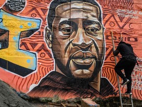 Kenyan mural artist Brian Esendi, also known as Bankslave, paints a graffiti mural in the Kibera slum in Nairobi on June 3 depicting the American, George Floyd, who died in police custody in Minneapolis.