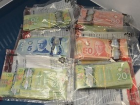 Chatham-Kent police found a large amount of Canadian cash (pictured), along with approximately $1,000 worth of cocaine, psilocybin and oxycodone tabs, when they executed a warrant at a residence in Chatham, Ont., on Tuesday, June 9, 2020. (Contributed Photo)