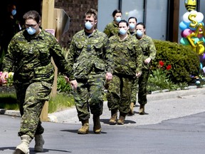 Members of the Canadian Armed Forces in front of Pickering's Orchard Villa long-term care home on Wednesday, May 6, 2020.
