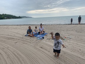 Grand Beach and Port Stanley's beaches reopened Monday morning, and St Thomas residents Rachel and Sai Yang (with kids Leah, 1, and Jackson, 2) were in Port Stanley's sand by 9 a.m. “We are so excited to have something to do with the kids . . . we can take a little bit of rain.” (Heather Rivers/The London Free Press)