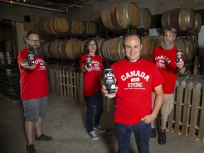Curt Collins, foreground, of Collins Formal Wear has teamed up with Forked River Brewery on his Canada Strong small business initiative. With him are Forked River Brewery owners David Reed, left, and Andrew Peters as well as Emma Earley, who designed the beer can. (Derek Ruttan/The London Free Press)