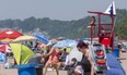 The beach at Port Stanley was busy but not overly so as most groups kept a distance apart, which is compressed by the long lens used. Photograph taken on Monday June 29, 2020. (Mike Hensen/The London Free Press)