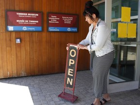 Molly McTiernan, visitor services coordinator at the Timmins Museum: National Exhibition Centre, was putting out the open sign board at the entrance of the museum as they reopened for the public on Monday morning. 

RICHA BHOSALE/The Daily Press