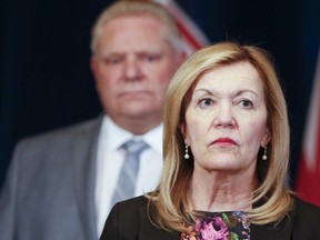 Christine Elliott, deputy premier and minisiter of health, with Premier Doug Ford in background.