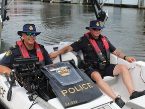 Sgt. Byron Newell (left) and Const. Russ Beaton of the OPP East Region SAVE, were among a large contingent of police stationed at the Port Rowan Marina on Sunday during the annual Pottahawk boat party.