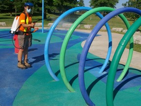 Brittany Greenway sanitizes the Pinafore Park splashpad prior to Wednesday’s opening. A daily cleaning of the city’s three splashpads is part of the routine for the recent Nipissing University criminology graduate, a St. Thomas parks summer employee, and co-workers.
(Eric Bunnell, Special to Postmedia Network)