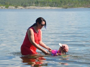Stacey Bordeleau plays with granddaughter Alana Pyette-Lachapelle at the beach off Portage Avenue on a sweltering day earlier this week. A heat warning for Sudbury was implemented Tuesday and extended on Thursday as the hot, muggy weather showed no signs of abating.