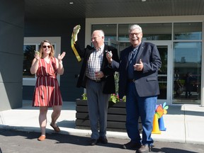 Stephanie Smith, director of the Pincher Creek Community Early Learning Centre, Town of Pincher Creek Mayor Don Anderberg, middle, and M.D. of Pincher Creek Reeve Brian Hammond do the honours July 3 of cutting the ribbon, commemorating the opening of the Sage Early Learning Centre, located by St. Michael's School.