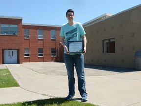Zack Renschler stands outside of Matthew Halton School with his Dr. Lloyd Cavers Scholarship.