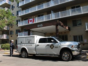 An official with the Ontario Fire Marshal is shown Tuesday morning outside an apartment building on Trillium Park. City police said a woman died earlier in the morning in connection with an apartment fire.