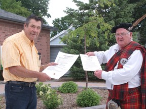 West Elgin Deputy Mayor Richard Leatham and Town Crier Dave Phillips in the main intersection in West Lorne. They are holding a stamped, signed and sealed copy of Phillips’ cry and two certificates for his Town Crying services for two deserving organizations. Submitted