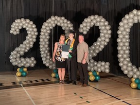 Fort High graduate Cole Reed, flanked by his parents, poses for a photo with his diploma. JENNIFER HAMILTON / THE RECORD