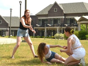 Whack! cast members Siobhan O’Malley, Fiona Mongillo, and Olivia Viggiani rehearse for a remount of the play for the upcoming Open-Air Theatre Festival on the backyard lawns at The Bruce Hotel. (Galen Simmons/The Beacon Herald)