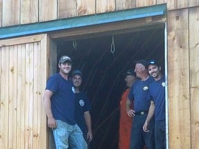 Members of the Chisholm Fire Department take a well-deserved rest after helping Mike and Wilma DeHaan store some bales of hay in their barn. Mike DeHaan was injured in a farming accident last week. Submitted Photo
